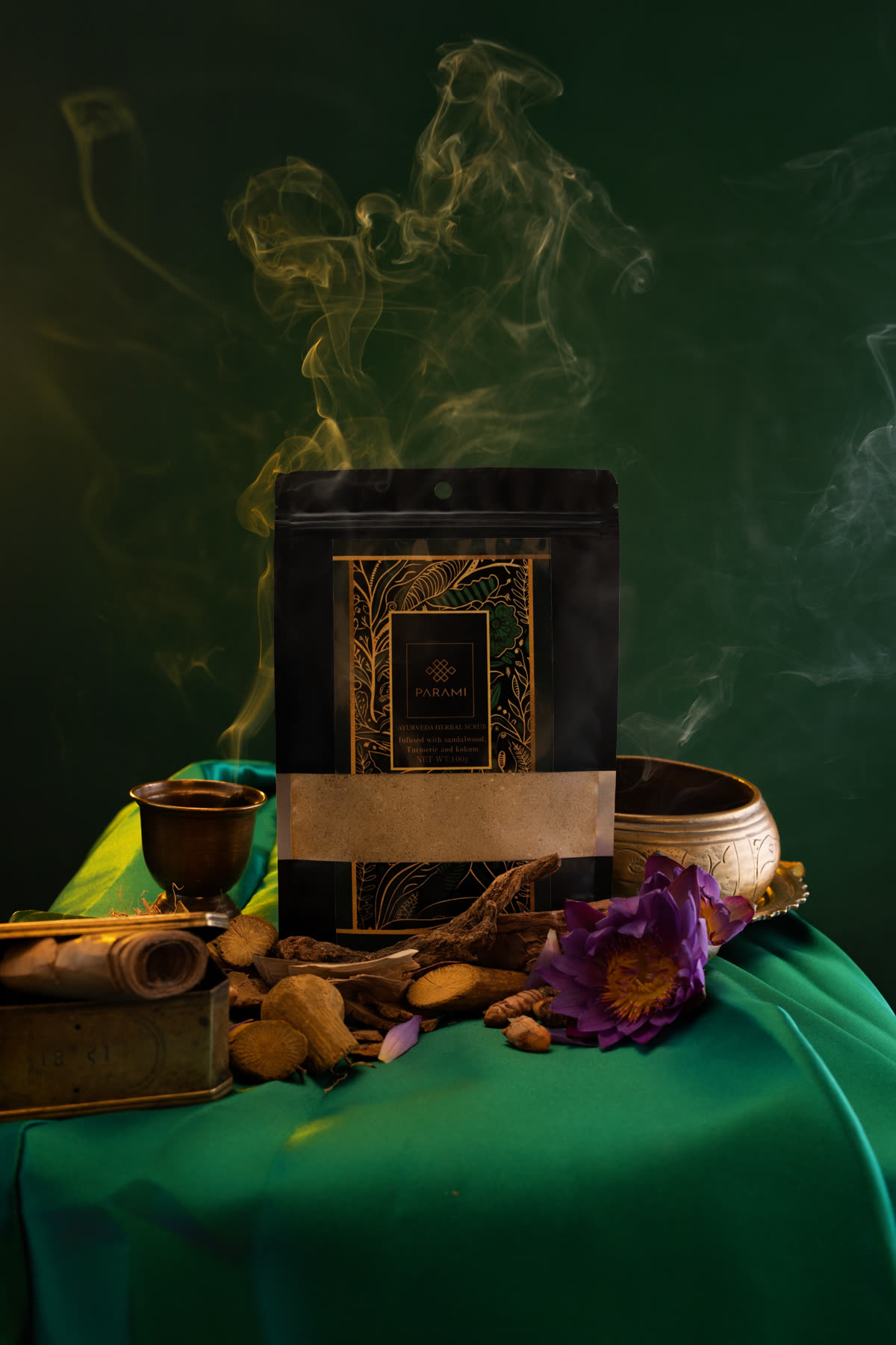 The pouch on green silk with a brass bowl and a thin rise of smoke